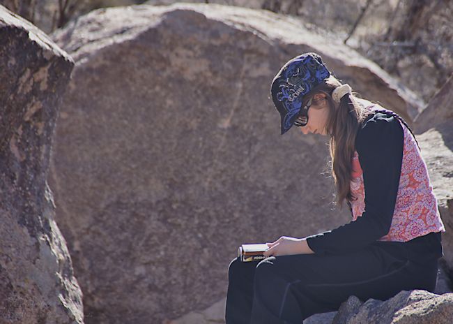 Munchkin reading about the different bouldering routes