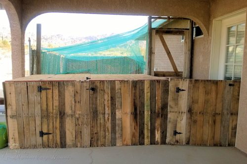 Gated chicken area made from pallets as well as the split chicken run door