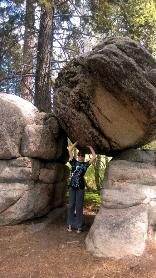 Munchkin acting like she's holding up the boulder