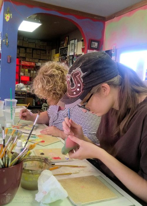 Munchkin and Grandma painting their pottery