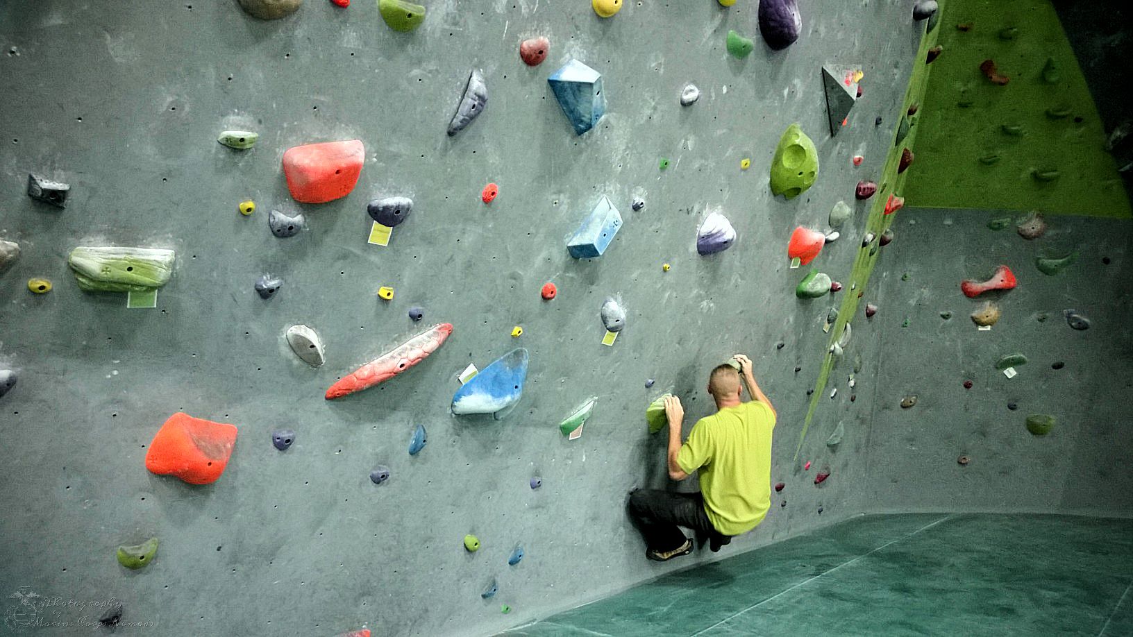 D trying a sit start route at Desert Rocks Climbing Gym