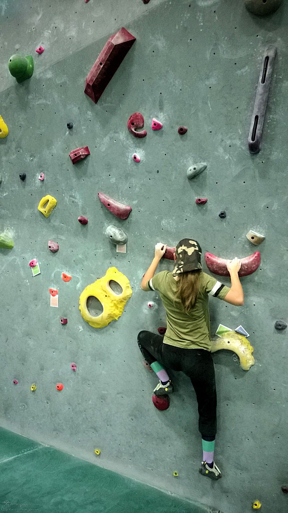 Munchkin trying out a crazy red route at Desert Rocks Climbing Gym