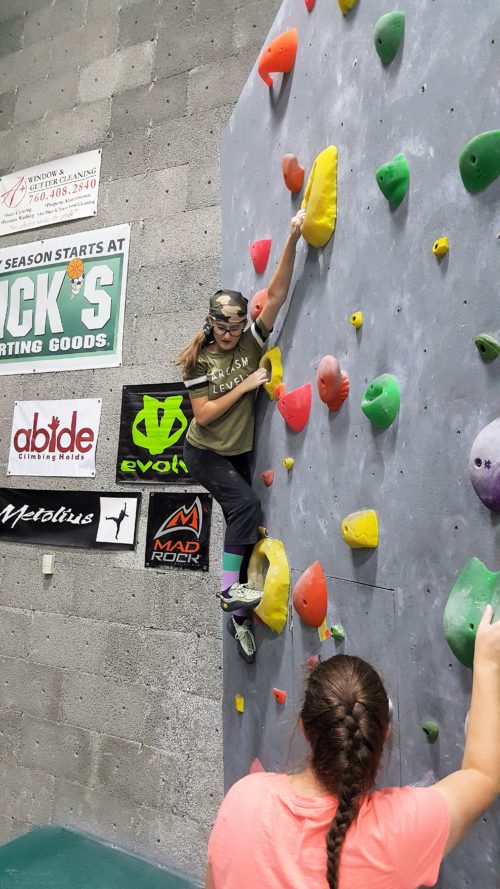 Munchkin doing a beginner yellow route with interesting holds at Desert Rocks Climbing Gym