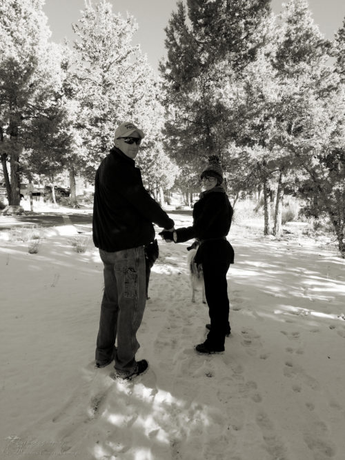 Daddy and daughter hand-in-hand hiking in the snow in Big Bear